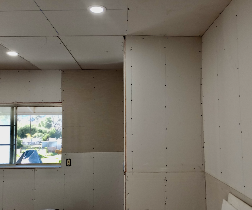 Completed drywall repair on a living room wall in Tampa, FL
